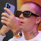 Justin Bieber on his phone at Super Bowl LVI on February 13, 2022 in Inglewood, California.